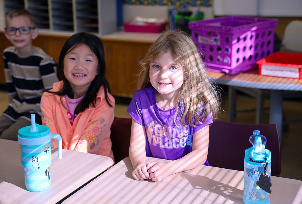 Students smiling on the first day of school.