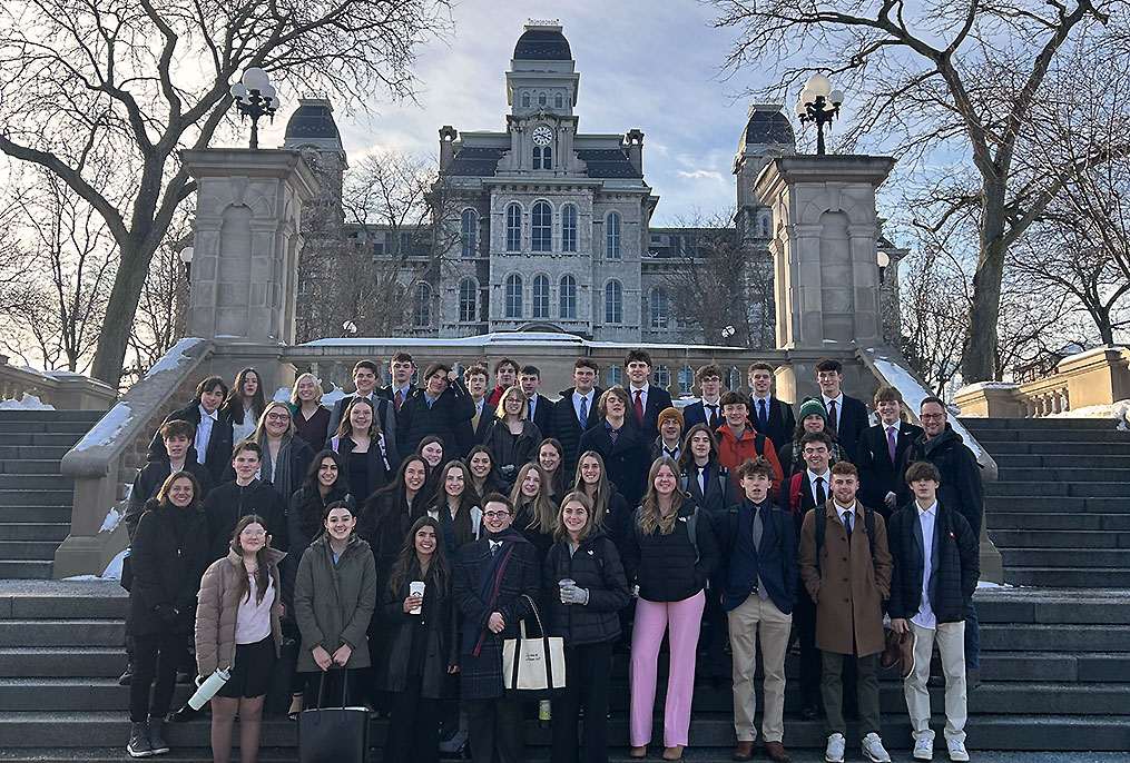 students standing in a group on an outdoor stair case at Syracuse University